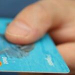 a close-up of a hand holding a debit card